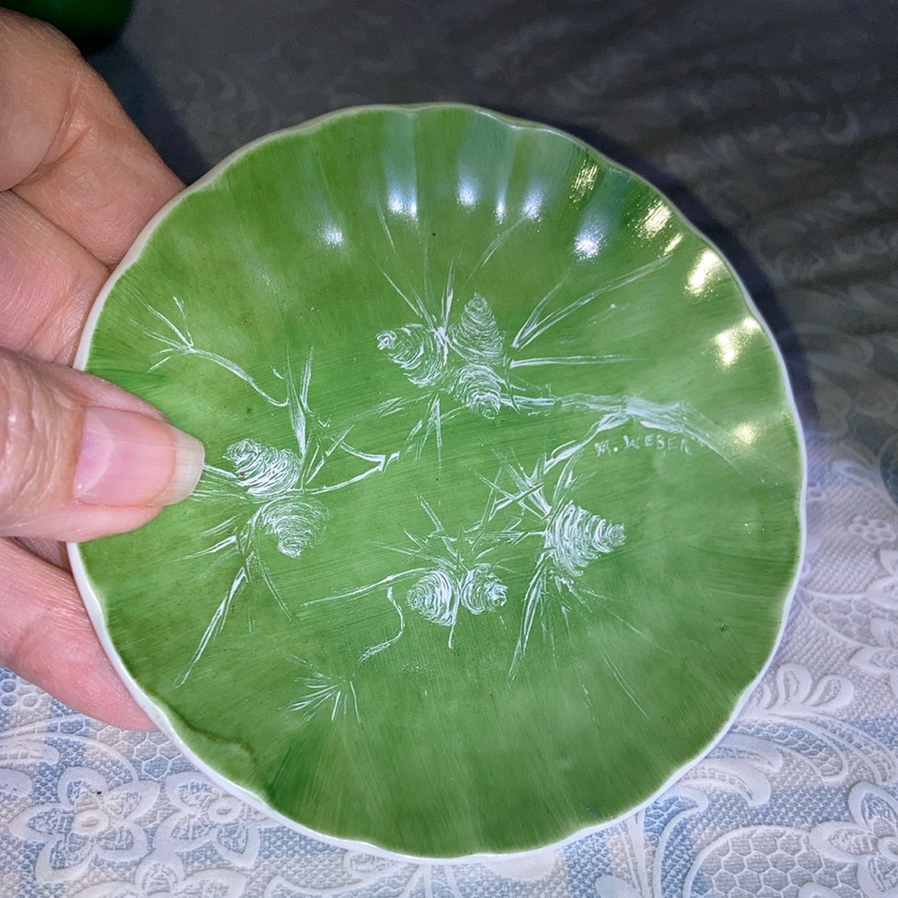 Artisan porcelain plate w/china painted pine cone scene. $11